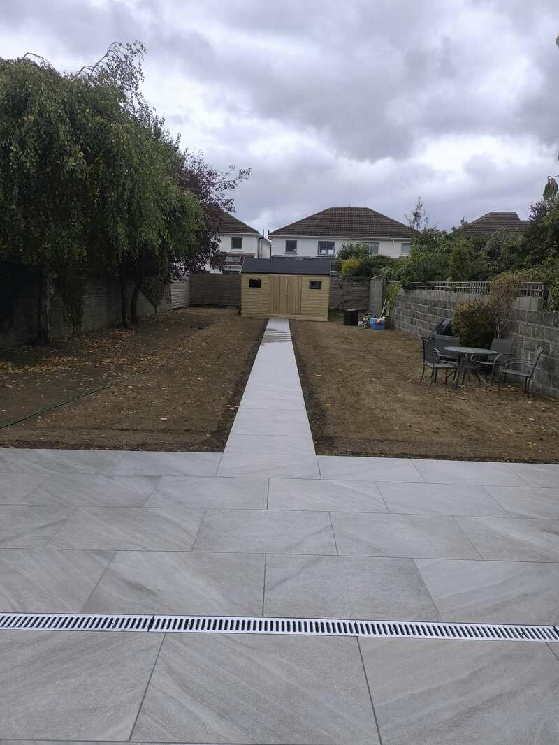 Tiled patio and pathway leading to garden shed