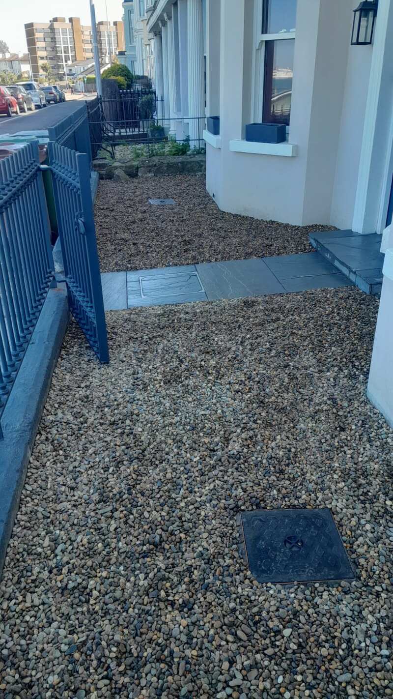 Front garden with gravel and dark slate path