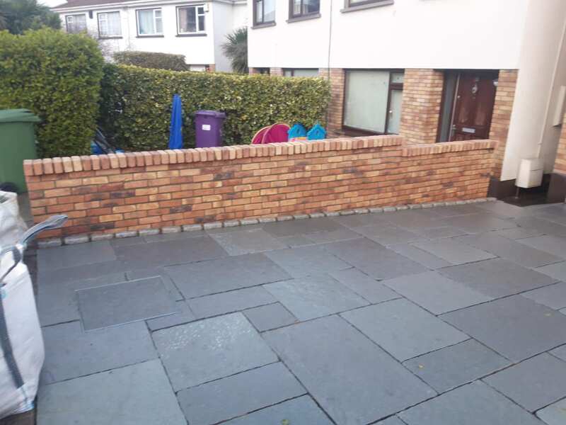 Dark slate patio with new brick boundary wall